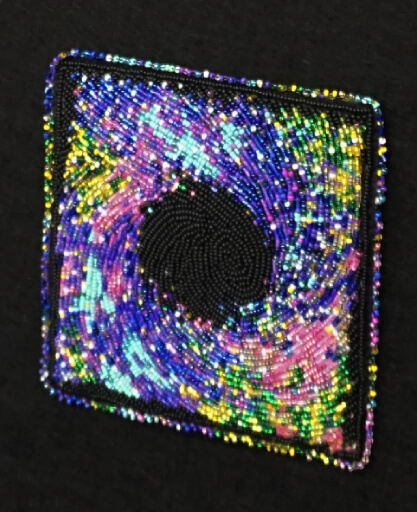 Close up of beadwork showing galaxy design