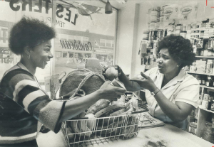 Two women in store at cash in black and white photo